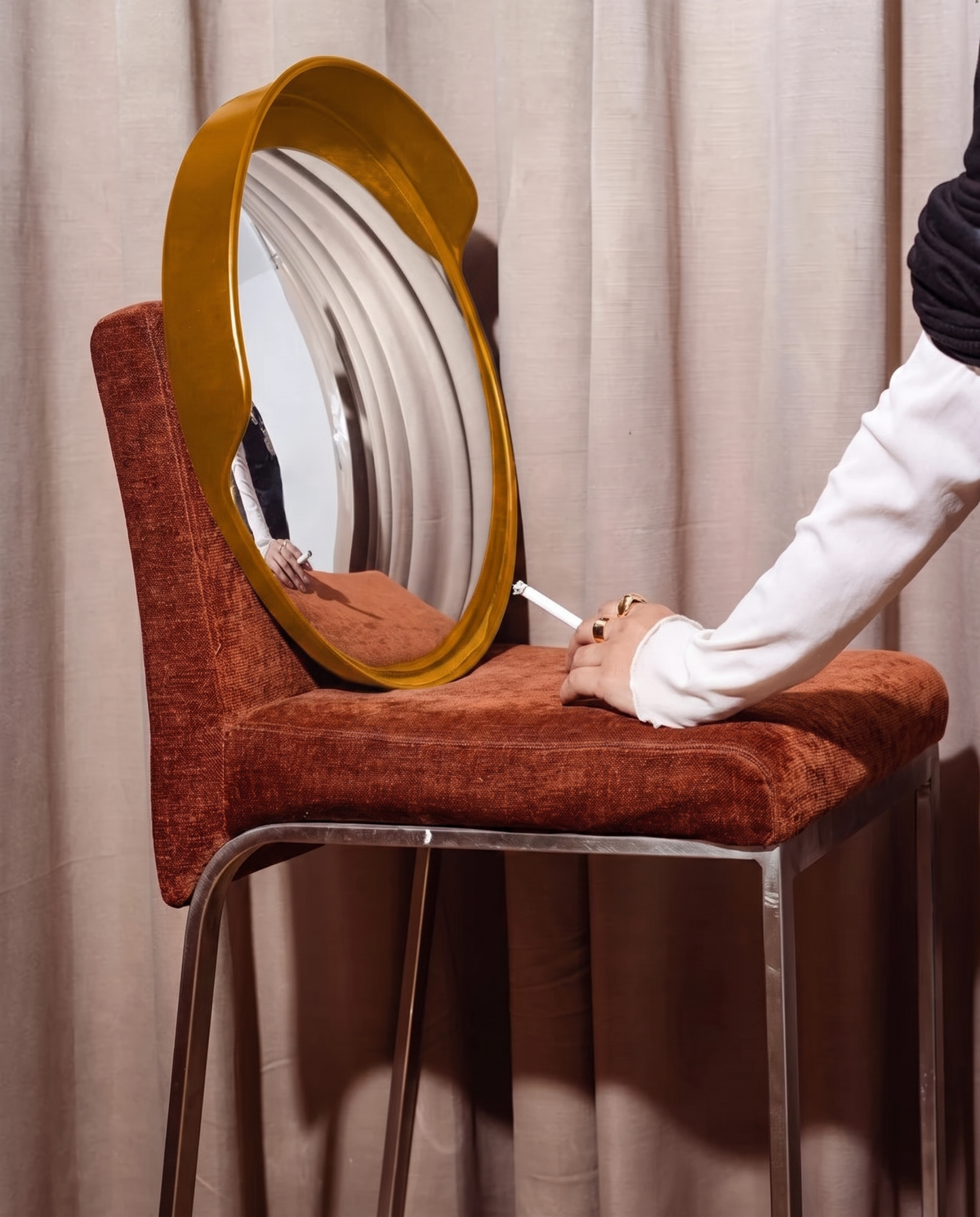 MIRROR SPECTACULAR in island yellow, propped on a rust-orange chair