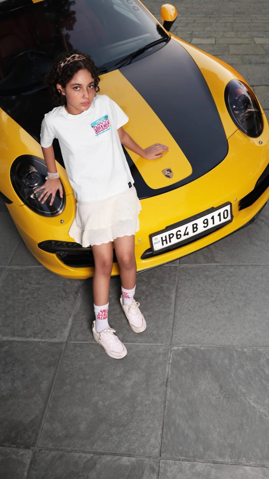 MrBeast Hello Beast tee worn against a yellow sports car