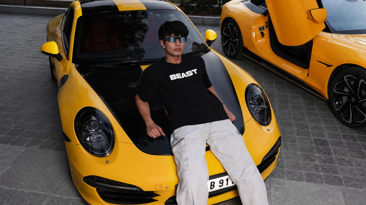 MrBeast block wordmark tee worn on a yellow sports car
